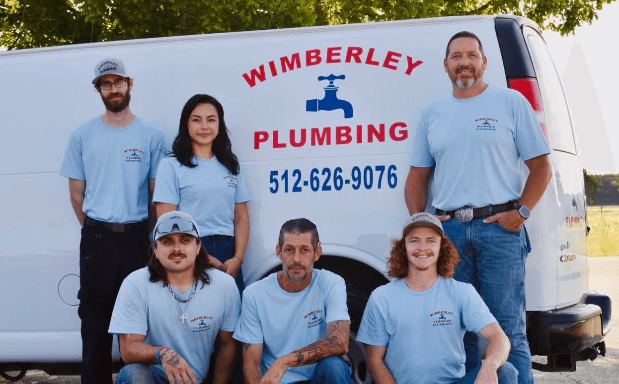 The Wimberley Plumbing crew in front of a company van